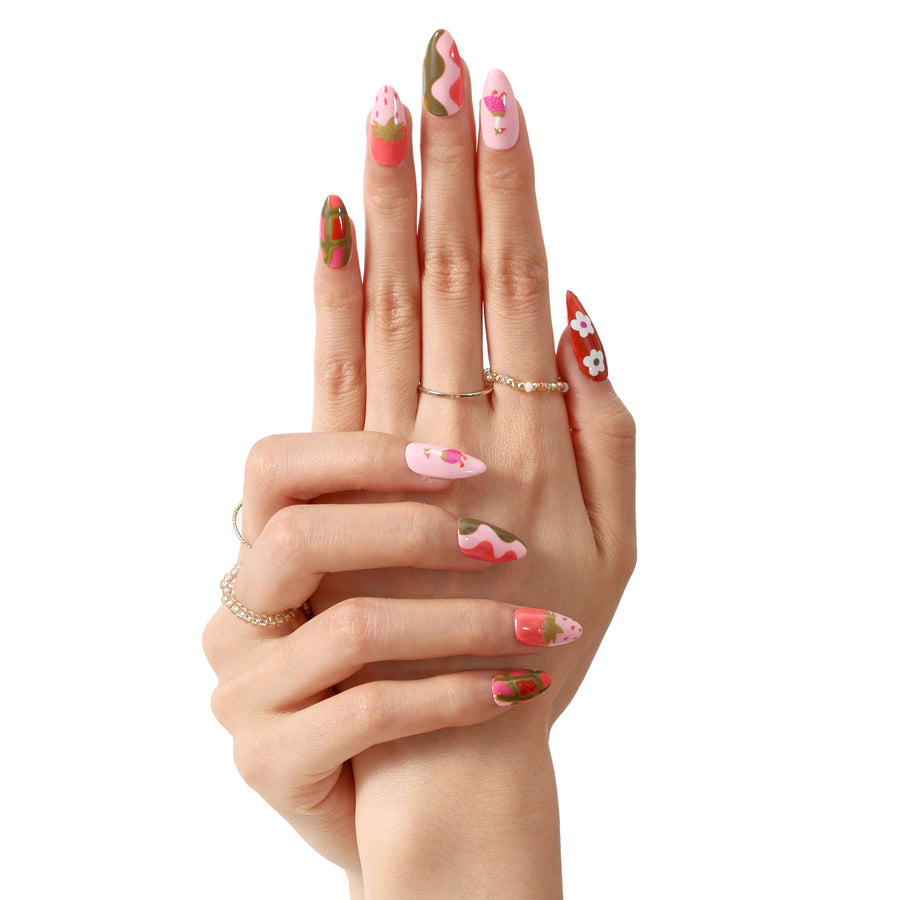 Strawberry Goose press-on nails with pink, green, and coral abstract patterns and strawberry designs.