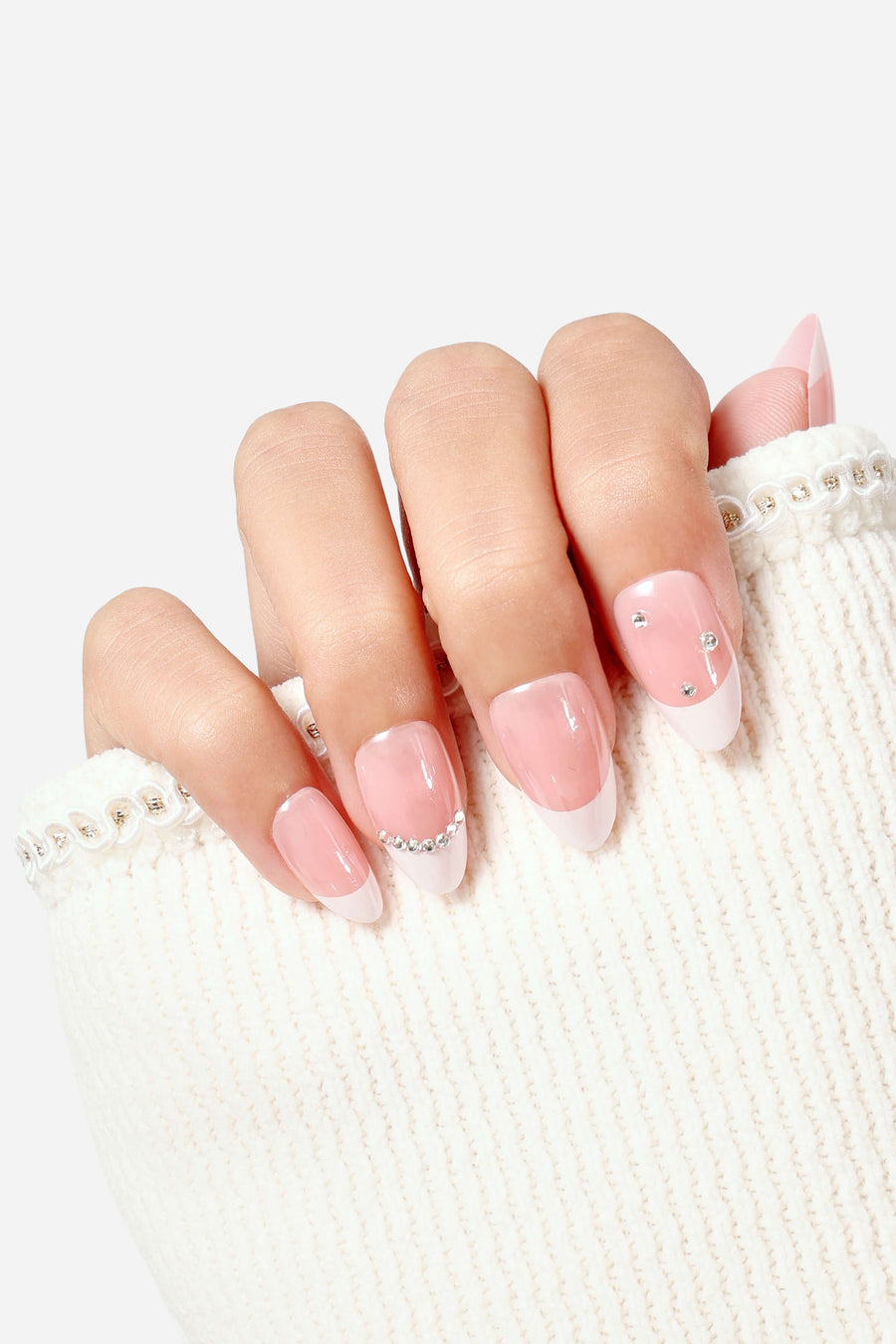 Short almond press-on nails with a French tip and crystal accents.