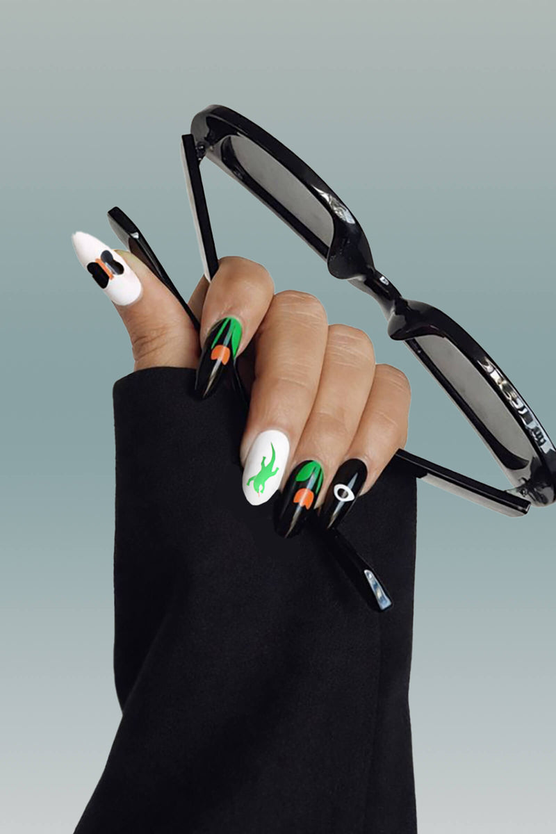 Ghost and Shark press-on nails by Lorien Stern: green lizard, orange mushrooms, black eye design.