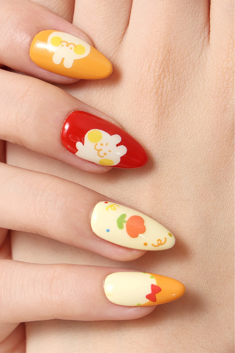 Press-on nails featuring a kawaii crayon box design with cute characters and fruit.