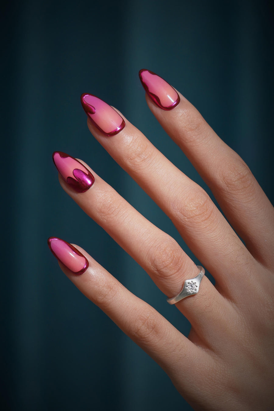 Sunset Chrome press-on nails with a pink gradient and metallic red accents.